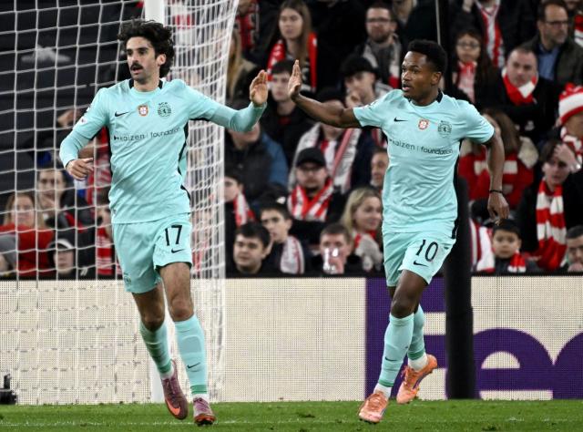 Sporting Lisbon's Portuguese forward #17 Francisco Trincao (L) celebrates scoring his team's second goal with Sporting Lisbon's Mozambican forward #10 Geny Catamo during the UEFA Champions League league phase day 8 football match between Athletic Club Bilbao and Sporting CP at San Mames Stadium in Bilbao on January 28, 2026. (Photo by ANDER GILLENEA / AFP)