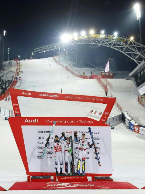 (L-R) Second placed Norway's Atle Lie Mcgrath, first placed Norway's Henrik Kristoffersen and third places France's Clement Noel celebrate on the podium after winning the second run of the men's Slalom event of FIS Alpine Skiing World Cup in Schladming, Austria, on January 28, 2026. (Photo by ERWIN SCHERIAU / APA / AFP) / Austria OUT