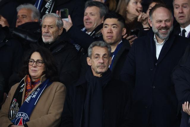 France's Sports Minister Marina Ferrari (L) and France's former President Nicolas Sarkozy (C) attend the  UEFA Champions League - League phase, Matchday 8 - football match between Paris Saint-Germain (PSG) and Newcastle United FC at the Parc des Princes stadium in Paris on January 28, 2026. (Photo by FRANCK FIFE / AFP)