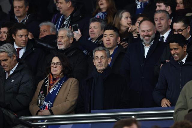 France's Sports Minister Marina Ferrari (L), former French President Nicolas Sarkozy (C) and Paris Saint Germain's Qatari president  Nasser al-Khelaifi (R) attend  the UEFA Champions League - League phase, Matchday 8 - football match between Paris Saint-Germain (PSG) and Newcastle United FC at the Parc des Princes stadium in Paris on January 28, 2026. (Photo by FRANCK FIFE / AFP)
