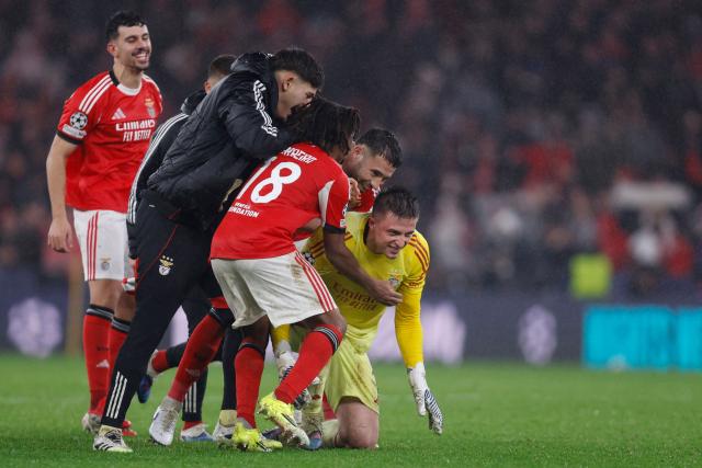 Benfica's Ukrainian goalkeeper #01 Anatoliy Trubin (R) celebrates after scoring his team's fourth goal during the UEFA Champions League league phase day 8 football match between SL Benfica and Real Madrid CF at Estadio da Luz in Lisbon on January 28, 2026. (Photo by FILIPE AMORIM / AFP)