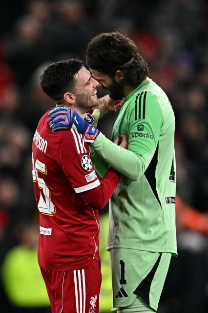 Liverpool's Scottish defender #26 Andrew Robertson (L) and Liverpool's Brazilian goalkeeper #01 Alisson Becker react following the UEFA Champions League football match between Liverpool and Qarabag at Anfield in Liverpool, north west England on January 28, 2026. (Photo by Paul ELLIS / AFP)