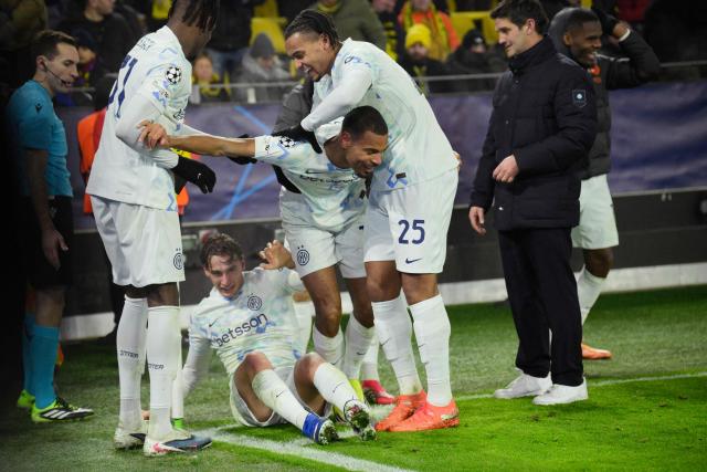 Inter Milan's French midfielder #17 Andy Diouf (3rd R) is celebrated by team mates after scoring the 0-2 goal during the UEFA Champions League league phase - day 8 football match between BVB Borussia Dortmund and Inter Milan in Dortmund, western Germany, on January 28, 2026. (Photo by Sascha Schuermann / AFP)