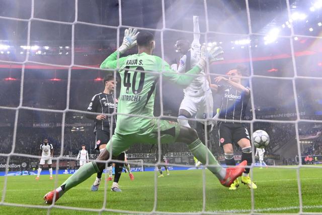 Tottenham Hotspur's French striker #39 Randal Kolo Muani (L) scores his team's first goal during the UEFA Champions League league phase- day 8 football match between Eintracht Frankfurt and Tottenham Hotspur in Frankfurt, western Germany, on January 28, 2026. (Photo by Kirill KUDRYAVTSEV / AFP)