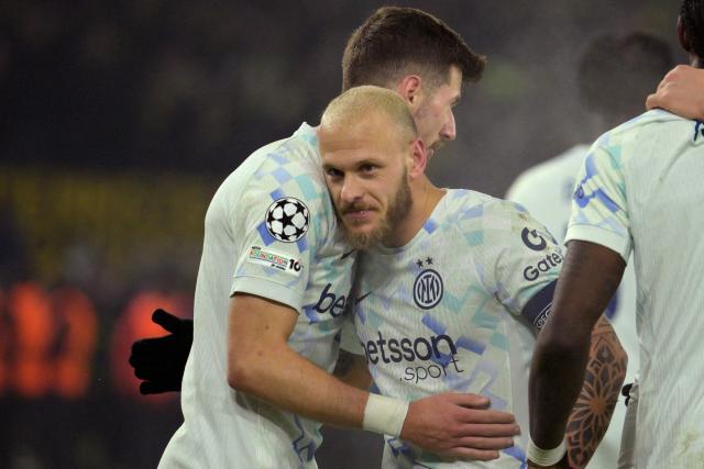 TOPSHOT - Inter Milan's Italian defender #32 Federico Dimarco (2nd L) celebrates with team mates  after scoring the opening goal 0-1 during the UEFA Champions League league phase - day 8 football match between BVB Borussia Dortmund and Inter Milan in Dortmund, western Germany, on January 28, 2026. (Photo by Sascha Schuermann / AFP)