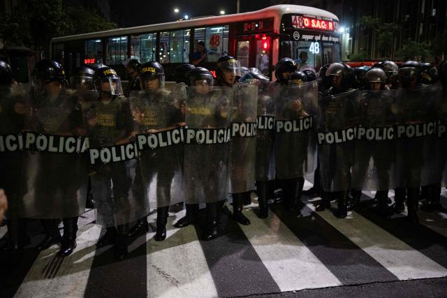 Riot police officers stand guard during a protest march called by Generation Z demanding the resignation of President Jeri in Lima on January 28, 2026. Peru's interim president, Jose Jeri, said on January 21 that he is the victim of a plot to force his resignation, in an appearance before a congressional committee investigating him for alleged influence peddling over a secret meeting with a Chinese businessman. (Photo by Ernesto BENAVIDES / AFP)