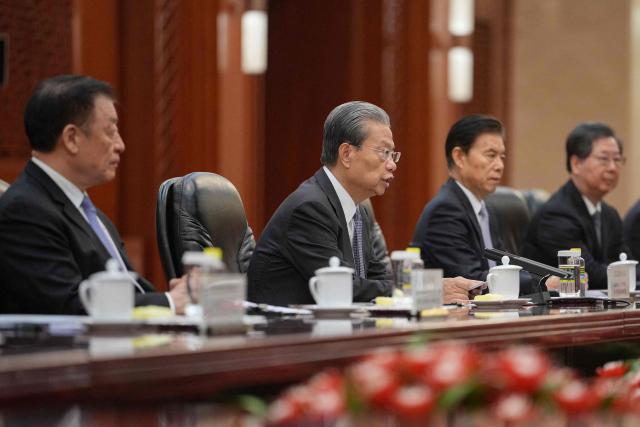 Zhao Leji (2nd L), Chairman of the Standing Committee of China’s National People’s Congress (NPC), speaks during a meeting with Britain's Prime Minister Keir Starmer (not pictured) at the Great Hall of the People in Beijing on January 29, 2026. Starmer arrived on January 28 for the first visit by a British prime minister to China since 2018, seeking to promote what he called "pragmatic" partnership with the Asian giant after years of fraught relations. (Photo by Kin Cheung / POOL / AFP)