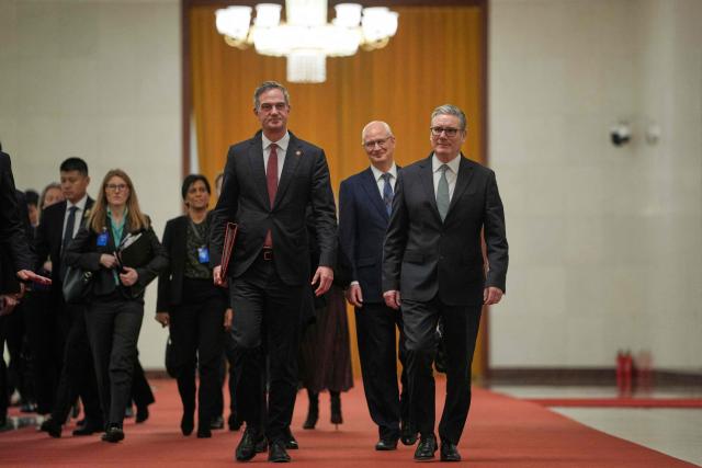 Britain's Prime Minister Keir Starmer (R) walks to his meeting with China's President Xi Jinping at the Great Hall of the People in Beijing on January 29, 2026. Starmer met with China's leader Xi Jinping in Beijing on January 29, state news agency Xinhua reported, with talks expected to  cover trade ties, national security and human rights. (Photo by Kin Cheung / POOL / AFP)