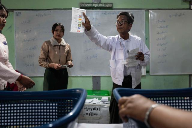 (FILES) Officials count advance votes at a polling station after voting ends for the third and final phase of Myanmar's general election in Mandalay on January 25, 2026. The colour of the winning party in Myanmar's junta-run election is the same green as a general's uniform, its staff are retired senior officers, and most expect it to march in lockstep with the military. The Union Solidarity and Development Party (USDP) claimed an overwhelming victory that indicates the country's armed forces, known as the Tatmadaw, intend to preserve their grip on power. But the top brass' decision to cloak its command in civilian dress means ceding some of junta chief Min Aung Hlaing's singular authority, analysts say. (Photo by ANTHONY WALLACE / AFP)