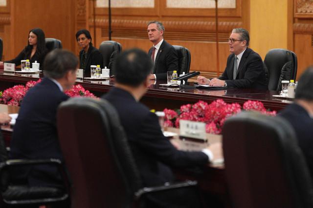 Britain's Prime Minister Keir Starmer (R) speaks during a meeting with China's President Xi Jinping at the Great Hall of the People in Beijing on January 29, 2026. China's President Xi Jinping told Britain's Prime Minister Keir Starmer their countries must "strengthen" ties to counter geopolitical headwinds, as the leaders met in Beijing on January 29. (Photo by Carl Court / POOL / AFP)