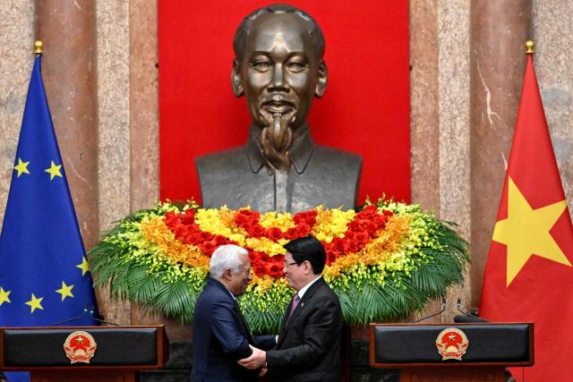 Vietnam's President Luong Cuong (R) and European Council President Antonio Costa greet each other during a meeting at the Presidential Palace in Hanoi on January 29, 2026. (Photo by Nhac NGUYEN / POOL / AFP)
