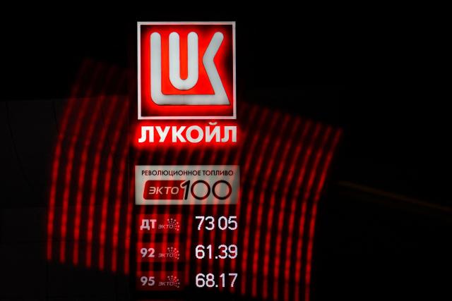 (FILES) This photograph shows a Lukoil logo at a gas station in Moscow on October 28, 2025. Russia's oil giant Lukoil, sanctioned by Washington over the Ukraine war, said on January 29, 2026 that it will sell its foreign assets to the US investment firm The Carlyle Group. (Photo by Olesya KURPYAYEVA / AFP)