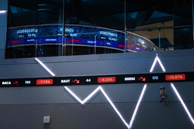 An electronic board displays stock prices at the Indonesia Stock Exchange (IDX) in Jakarta on January 29, 2026. (Photo by YASUYOSHI CHIBA / AFP)