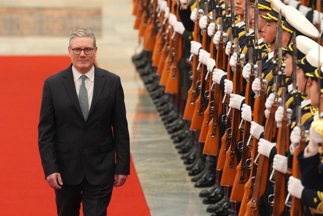 Britain's Prime Minister Keir Starmer inspects a Chinese honour guard with Chinese Premier Li Qiang (not pictured) during a welcome ceremony at the Great Hall of the People in Beijing on January 29, 2026. Chinese President Xi Jinping told Starmer their countries must "strengthen" ties to counter geopolitical headwinds, as the leaders met in Beijing on January 29. (Photo by Carl Court / POOL / AFP)