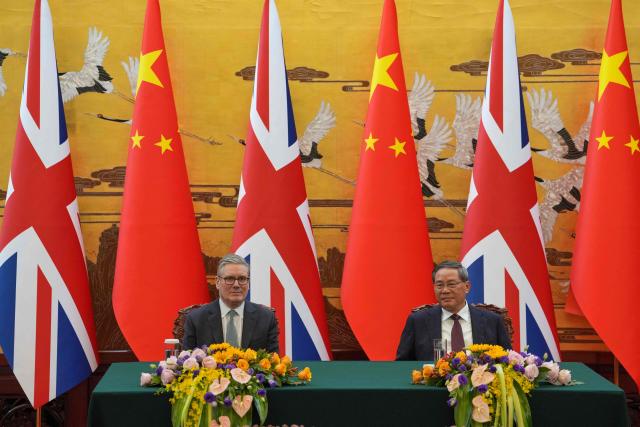 Britain's Prime Minister Keir Starmer (L) and Chinese Premier Li Qiang attend a signing ceremony held at the Great Hall of the People in Beijing on January 29, 2026. Chinese President Xi Jinping told Starmer their countries must "strengthen" ties to counter geopolitical headwinds, as the leaders met in Beijing on January 29. (Photo by Kin Cheung / POOL / AFP)