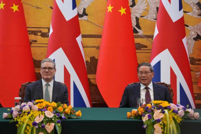 Britain's Prime Minister Keir Starmer (L) and Chinese Premier Li Qiang attend a signing ceremony held at the Great Hall of the People in Beijing on January 29, 2026. Chinese President Xi Jinping told Starmer their countries must "strengthen" ties to counter geopolitical headwinds, as the leaders met in Beijing on January 29. (Photo by Kin Cheung / POOL / AFP)