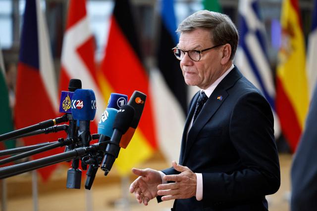Germany's Foreign Minister Johann Wadephul talks to journalists as he arrives for a EU Foreign Affairs Council meeting at the EU headquarters in Brussels on January 29, 2026. The Council is expected to discuss the latest developments in Ukraine with discussions focused on peace negotiations, support for Ukraine and pressure on Russia. (Photo by SIMON WOHLFAHRT / AFP)