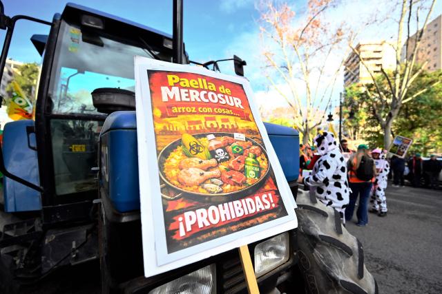 A placard reading "Mercosur paella. Rice with... forbidden things!" is seen on a tractor during a protest against the EU-Mercosur trade deal and the economic pressures facing the agricultural sector in Valencia, on January 29, 2026. (Photo by Jose JORDAN / AFP)
