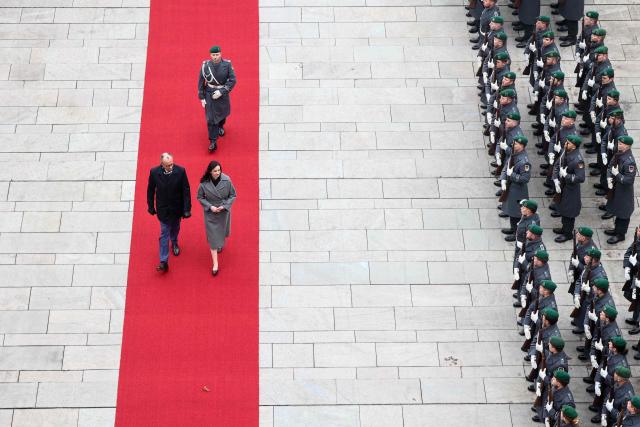 German Chancellor Friedrich Merz and Lithuania's Prime Minister Inga Ruginiene review a military honor guard during a welcome ceremony in front of the Chancellery in Berlin, on January 29, 2026. (Photo by Liesa Johannssen / POOL / AFP)