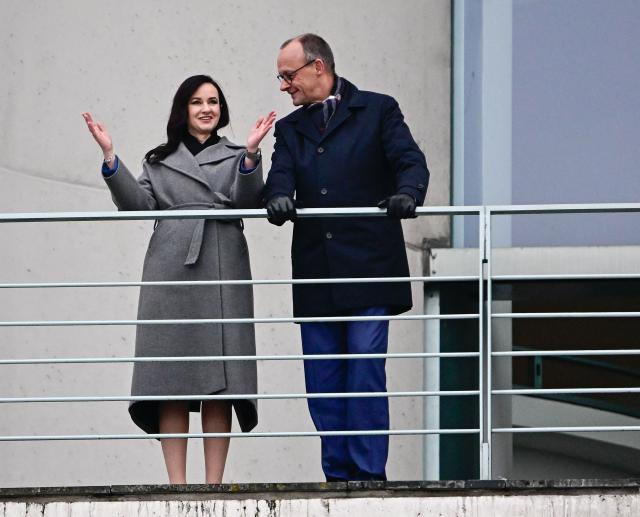 German Chancellor Friedrich Merz and Lithuania's Prime Minister Inga Ruginiene talk on the balcony of the Chancellery in Berlin, on January 29, 2026. (Photo by Tobias SCHWARZ / AFP)