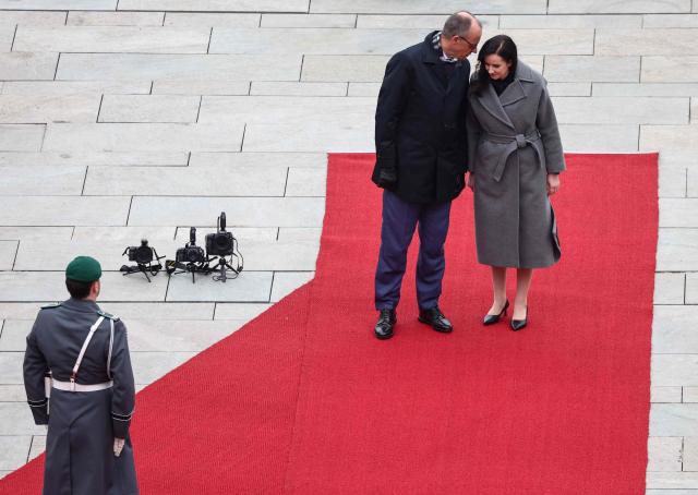 German Chancellor Friedrich Merz and Lithuania's Prime Minister Inga Ruginiene review a military honor guard during a welcome ceremony in front of the Chancellery in Berlin, on January 29, 2026. (Photo by Liesa Johannssen / POOL / AFP)