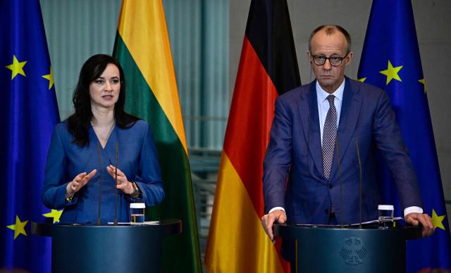 Lithuania's Prime Minister Inga Ruginiene and German Chancellor Friedrich Merz address a joint press conference at the Chancellery in Berlin, Germany, on January 29, 2026. (Photo by Tobias SCHWARZ / AFP)