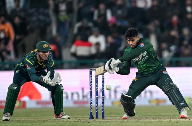 Pakistan's Usman Khan (R) plays a shot during the first Twenty20 international cricket match between Pakistan and Australia at the Gaddafi Stadium in Lahore on January 29, 2026. (Photo by Arif ALI / AFP)