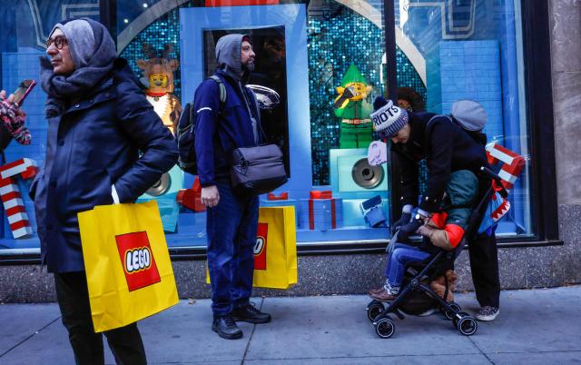 (FILES) People shop Black Friday deals outside the Lego store in New York City, November 28, 2025. Manufacturing a doll or a Lego block in Mexico requires large amounts of plastic, imported mainly from Asia. Like other industries, the toy sector is being affected by the trade tensions between the US government of Donald Trump, Mexico and China. (Photo by kena betancur / AFP)