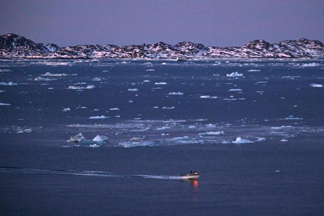 A boat is seen navigating past ice blocks at the coastline of Nuuk, Greenland, on January 29, 2026. (Photo by Ina FASSBENDER / AFP)