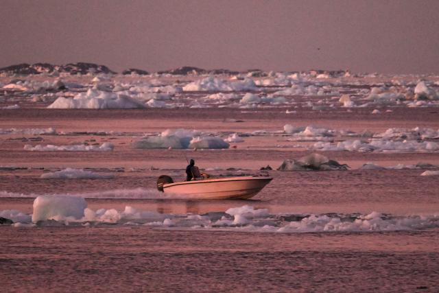 A boat is seen navigating past ice blocks near the harbour of Nuuk, Greenland, on January 29, 2026. (Photo by Ina FASSBENDER / AFP)
