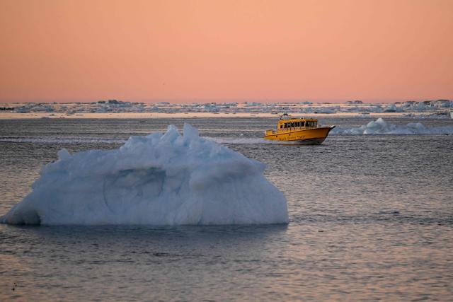 A Nuuk Water Taxi navigates past an ice block floating off the coastline of Nuuk, Greenland, on January 29, 2026. (Photo by Ina FASSBENDER / AFP)
