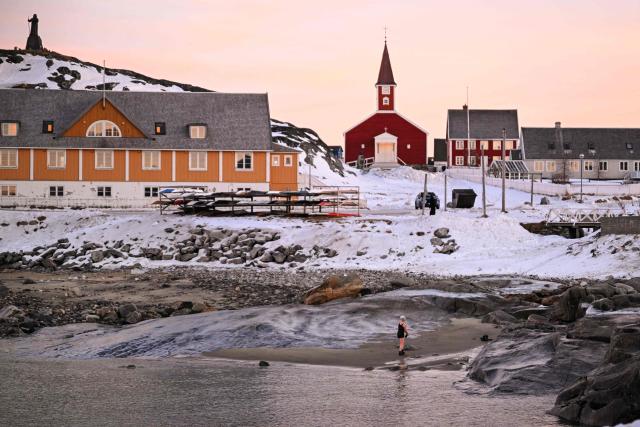 A woman comes out of the water in Nuuk, Greenland, on January 29, 2026. (Photo by Ina FASSBENDER / AFP)