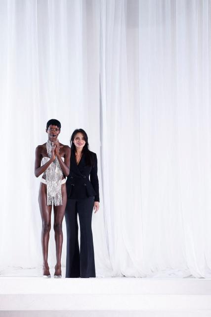 Greek fashion designer Celia Kritharioti (R) acknowledges the audience at the end of the Celia Kritharioti Women's Haute Couture Spring/Summer 2026 collection fashion show as part of the Paris Haute Couture Fashion Week, in Paris, on January 29, 2026. (Photo by Ian LANGSDON / AFP)