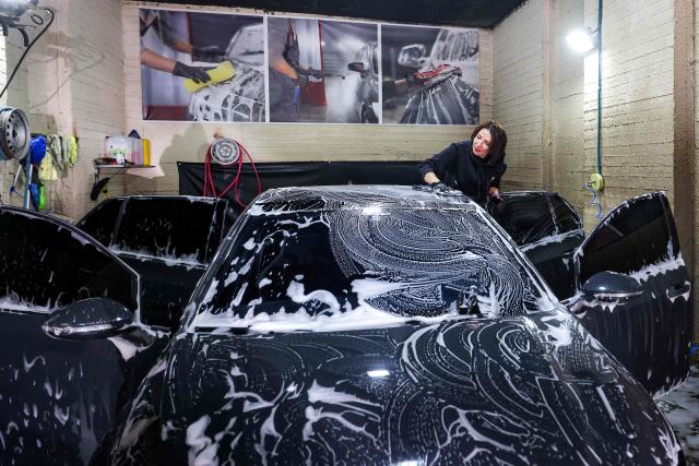 Hanadi Hadya, a 36-year-old Palestinian woman who opened her own carwash, washes a vehicle with foam soap at her shop in Beit Jala in the centre of the occupied West Bank on January 29, 2026. (Photo by HAZEM BADER / AFP)