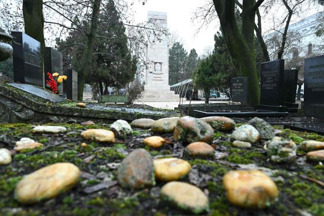 Stones are placed next to graves at Budapest's largest Jewish cemetery, where completely renovated war memorials were unveiled during a ceremony on January 29, 2026. Hungarian government officials and Jewish community leaders unveiled monuments dedicated to Jewish soldiers who died fighting for Austro-Hungary in World War I and to the unknown victims of forced labour in World War II. (Photo by Attila KISBENEDEK / AFP)