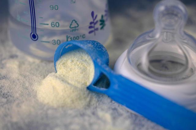This photograph shows a spoonfull of infant milk formula and an infant feeding bottle in Quimper, western France January 29, 2026. The infant formula affair, already the subject of two investigations opened in France after the deaths of two infants, enters a new legal phase on January 29, 2026 with a complaint filed in Paris by the association Foodwatch and eight families, who accuse the industry and the government of failing to act in time. (Photo by Fred TANNEAU / AFP)