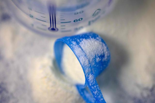 This photograph shows a spoonfull of infant milk formula and an infant feeding bottle in Quimper, western France January 29, 2026. The infant formula affair, already the subject of two investigations opened in France after the deaths of two infants, enters a new legal phase on January 29, 2026 with a complaint filed in Paris by the association Foodwatch and eight families, who accuse the industry and the government of failing to act in time. (Photo by Fred TANNEAU / AFP)