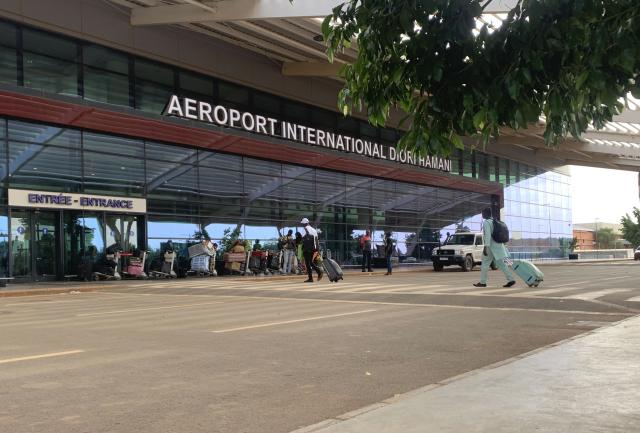 (FILES) Passengers arrive at the Diori Hamani International airport in Niamey on September 22, 2023. Heavy security was deployed around Niger's main airport on March 29, 2026 after overnight gunfire and explosions raised suspicions of a jihadist attack, but the ruling junta remained tight-lipped. (Photo by AFP)
