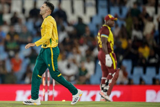 South Africa's Keshav Maharaj (L) celebrates after the dismissal of West Indies' Rovman Powell (R) during the second Twenty20 international cricket match between South Africa and West Indies at SuperSport Park in Centurion on January 29, 2026. (Photo by PHILL MAGAKOE / AFP)