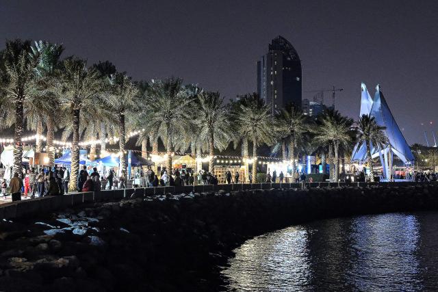 People walk along Kuwait City's Scientific Centre beachfront on January 29, 2026. (Photo by YASSER AL-ZAYYAT / AFP)