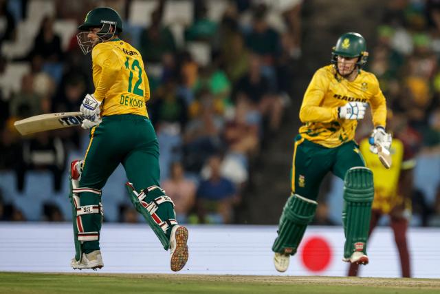 South Africa's Quinton de Kock (L) and South Africa's Ryan Rickelton (R) run between the wickets during the second Twenty20 international cricket match between South Africa and West Indies at SuperSport Park in Centurion on January 29, 2026. (Photo by PHILL MAGAKOE / AFP)