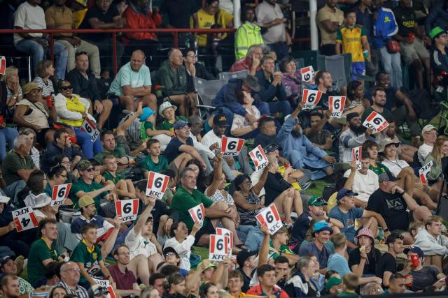 South African supporters holds up signes reading "6" after South Africa's Quinton de Kock hit a six during the second Twenty20 international cricket match between South Africa and West Indies at SuperSport Park in Centurion on January 29, 2026. (Photo by PHILL MAGAKOE / AFP)