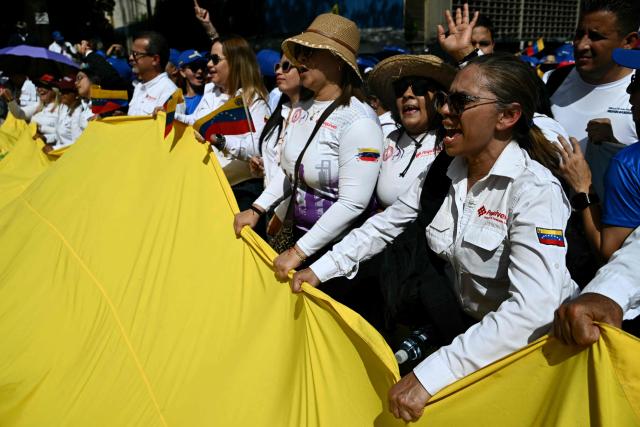 Government supporters take part in a march called by the United Socialist Party of Venezuela (PSUV) in support of the Hydrocarbons Law and demanding the release of ousted President Nicolas Maduro, in Caracas on January 29, 2026. (Photo by RONALDO SCHEMIDT / AFP)