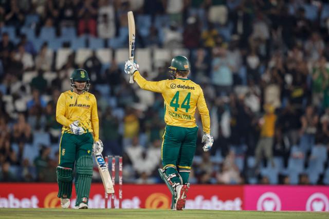 South Africa's Ryan Rickelton (R) celebrates after scoring a half-century (50 runs) during the second Twenty20 international cricket match between South Africa and West Indies at SuperSport Park in Centurion on January 29, 2026. (Photo by PHILL MAGAKOE / AFP)