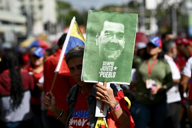 Government supporters take part in a march called by the United Socialist Party of Venezuela (PSUV) in support of the Hydrocarbons Law and demanding the release of ousted President Nicolas Maduro, in Caracas on January 29, 2026. (Photo by RONALDO SCHEMIDT / AFP)