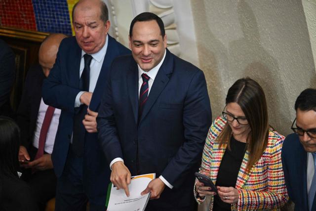 The president of Venezuelan state oil company PDVSA, Hector Obregon (C) reacts during the debate on the Bill for the Partial Reform of the Organic Law on Hydrocarbons at the National Assembly in Caracas on January 29, 2026. (Photo by Federico PARRA / AFP)