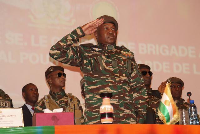 (FILES) The head of Niger's military regime, General Abdourahamane Tiani (C) attends the opening of the commission responsible for conducting the national conference in Niamey on February 15, 2025. The head of Niger's junta on January 29, 2026 thanked Russia for its help in foiling an attack on Niamey's airport and accused the presidents of France, Benin and Ivory Coast of backing those responsible. (Photo by AFP)
