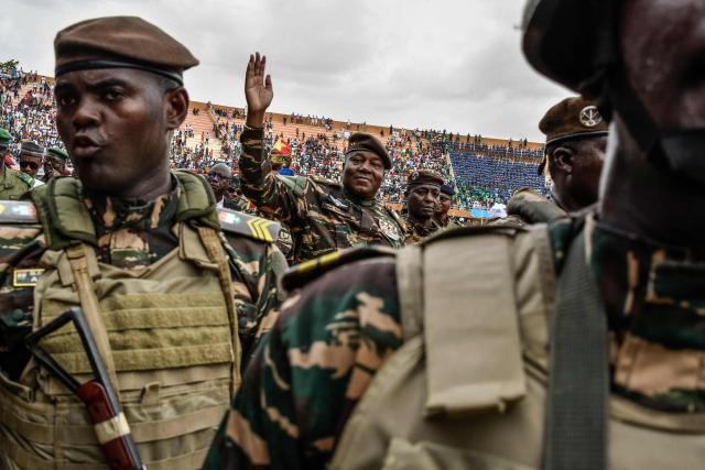 (FILES) General Abdourahamane Tiani (C), the head of the military regime in Niger, greets the thousands of people who gathered at the largest stadium in Niamey for the launch of festivities marking the first anniversary of his coming to power after the July 26, 2023 coup that overthrew civilian president Mohamed Bazoum on July 26, 204. The head of Niger's junta on January 29, 2026 thanked Russia for its help in foiling an attack on Niamey's airport and accused the presidents of France, Benin and Ivory Coast of backing those responsible. (Photo by BOUREIMA HAMA / AFP)