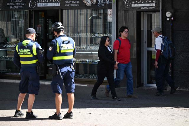 Municipal police officers patrol the city center of San Jose on January 29, 2026. Right-wing politician Laura Fernandez appears set to win Costa Rica's presidential election in the first round, according to two opinion polls published on January 21. (Photo by Marvin RECINOS / AFP)