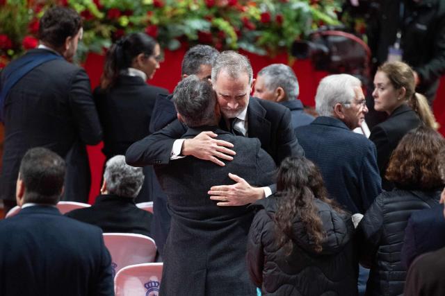 Spain's King Felipe VI hugs an attendee during a funeral mass for the victims of the trains accident who killed 45 persons in Adamuz, on January 29, 2026, in Huelva. The January 18 accident near the southern village of Adamuz - one of Europe's deadliest rail disasters this century - has raised questions about the country's rail safety. (Photo by JORGE GUERRERO / AFP)
